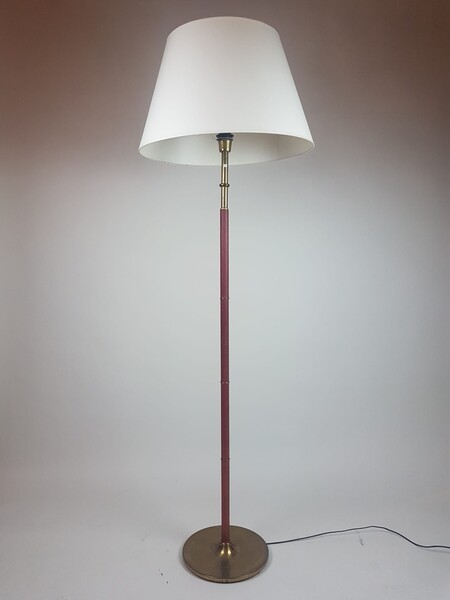 Floor lamp in brass sheathed in red leather, circa 1950