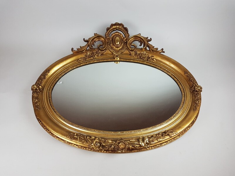 Oval mirror in wood and gilded stucco, late 19th