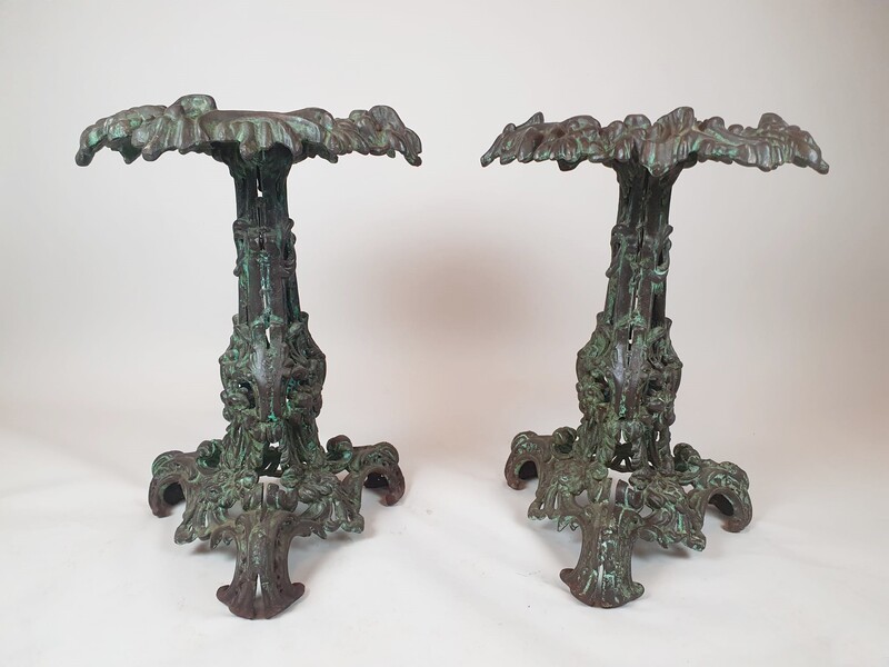 Pair of patinated cast iron pedestal tables