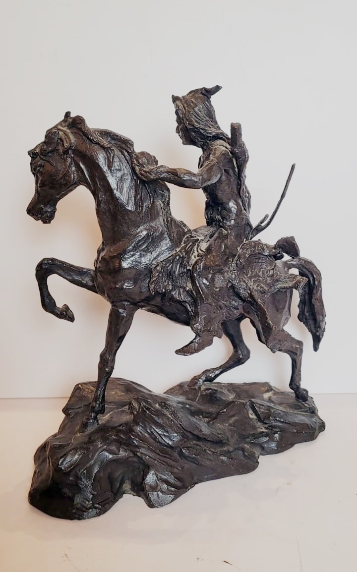 Bronze sculpture with dark patina representing an Indian on his horse