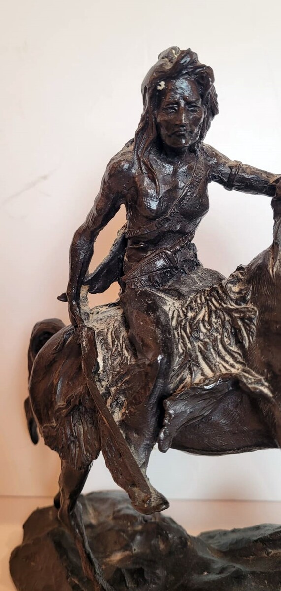 Bronze sculpture with dark patina representing an Indian on his horse