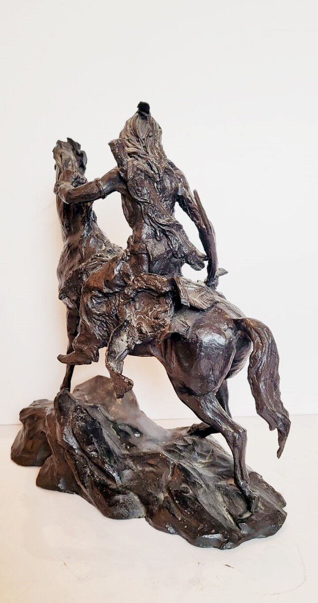 Bronze sculpture with dark patina representing an Indian on his horse