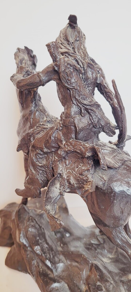 Bronze sculpture with dark patina representing an Indian on his horse