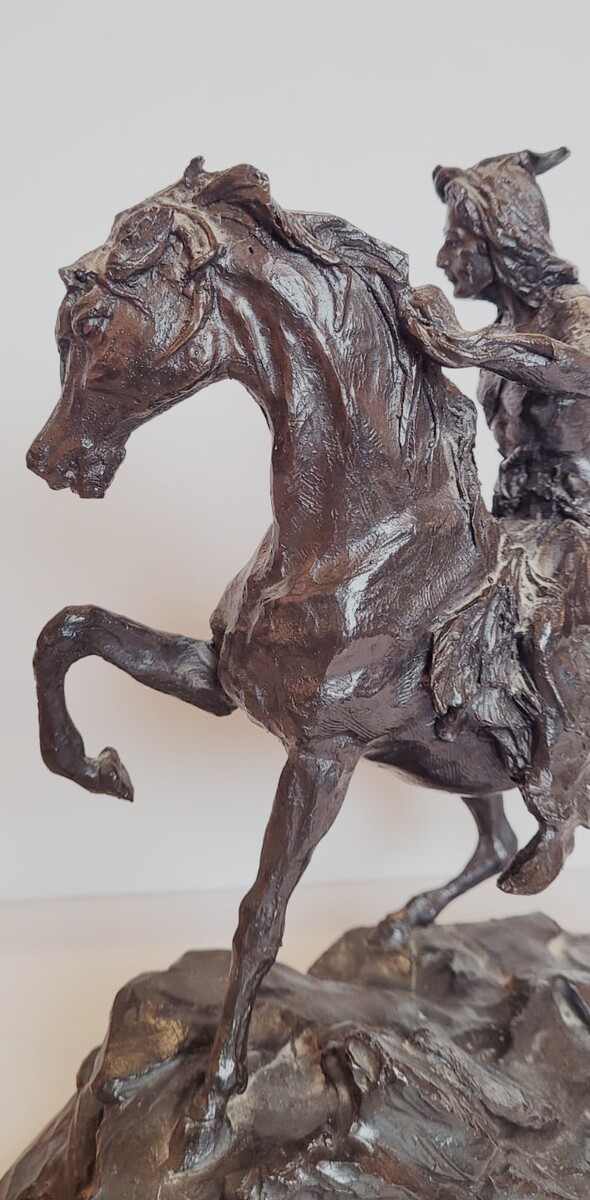 Bronze sculpture with dark patina representing an Indian on his horse