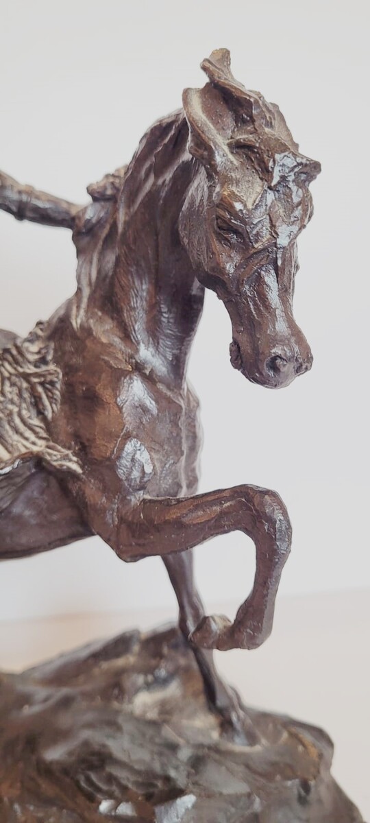 Bronze sculpture with dark patina representing an Indian on his horse