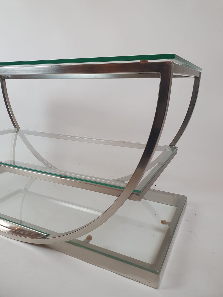 Brushed steel coffee table with glass shelves, circa 1970