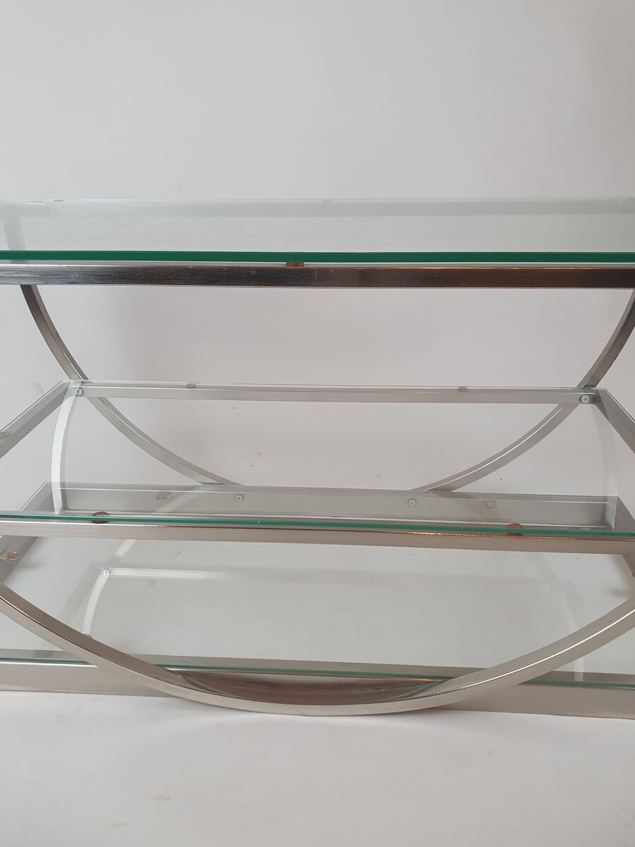 Brushed steel coffee table with glass shelves, circa 1970