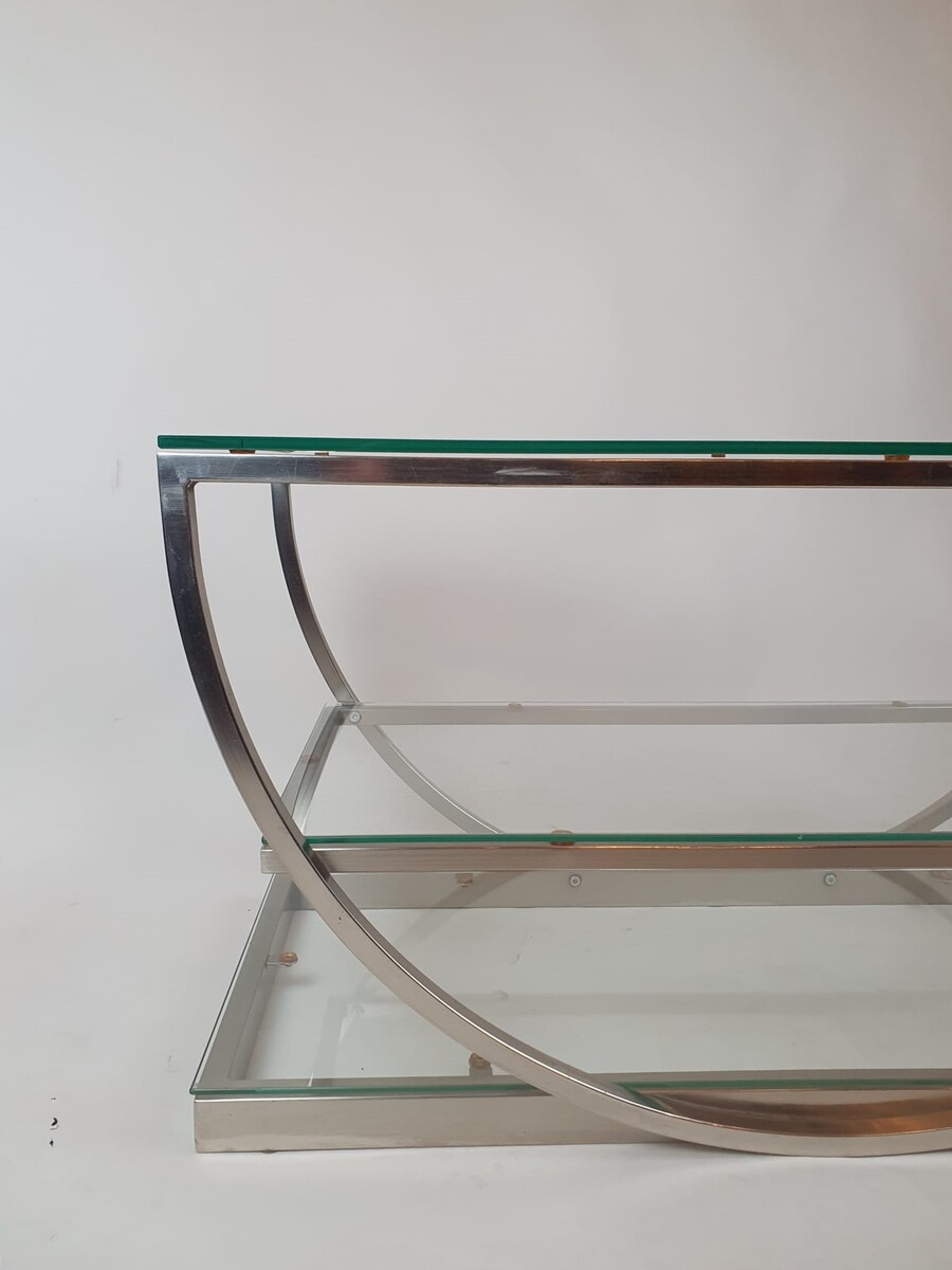 Brushed steel coffee table with glass shelves, circa 1970