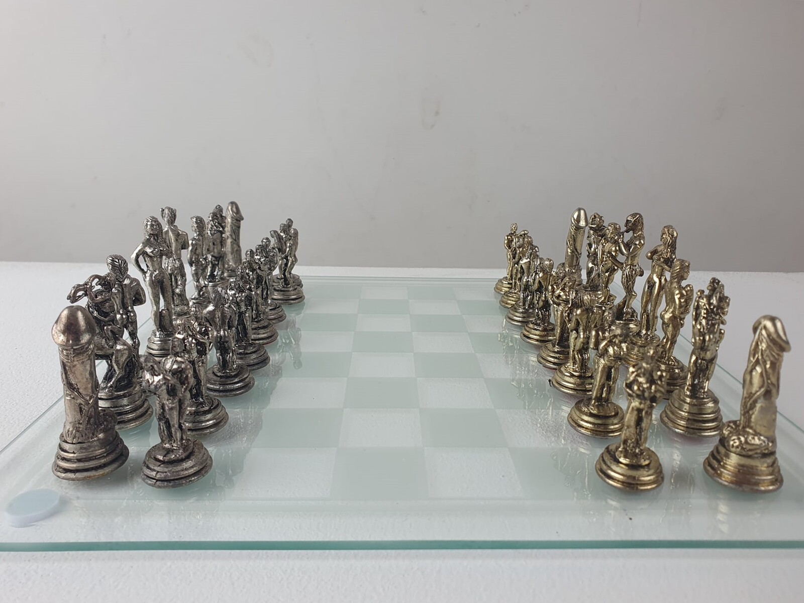 Erotic chessboard in silver metal and glass top