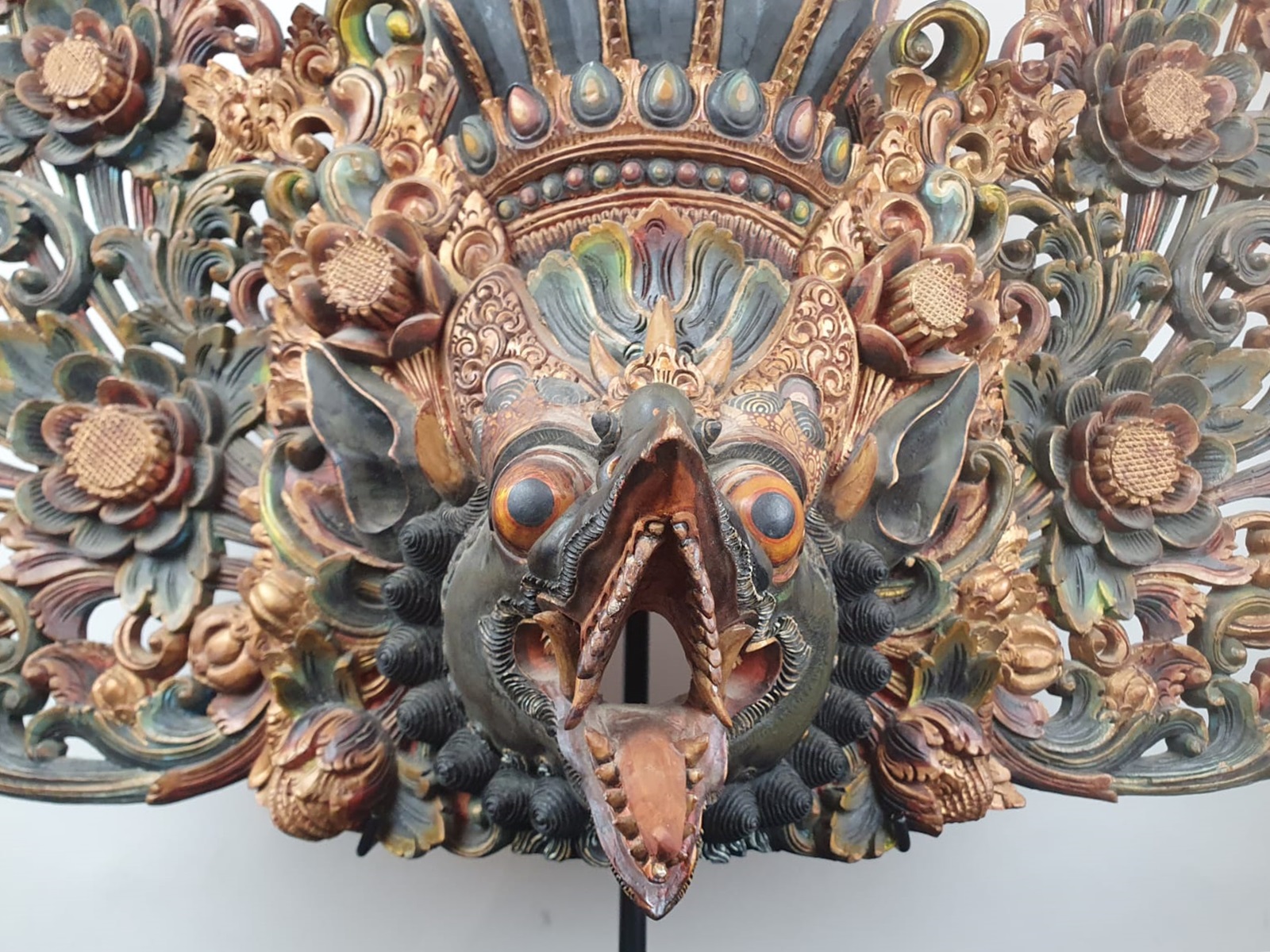 Finely carved polychrome wooden Balinese mask representing a dragon, 20th