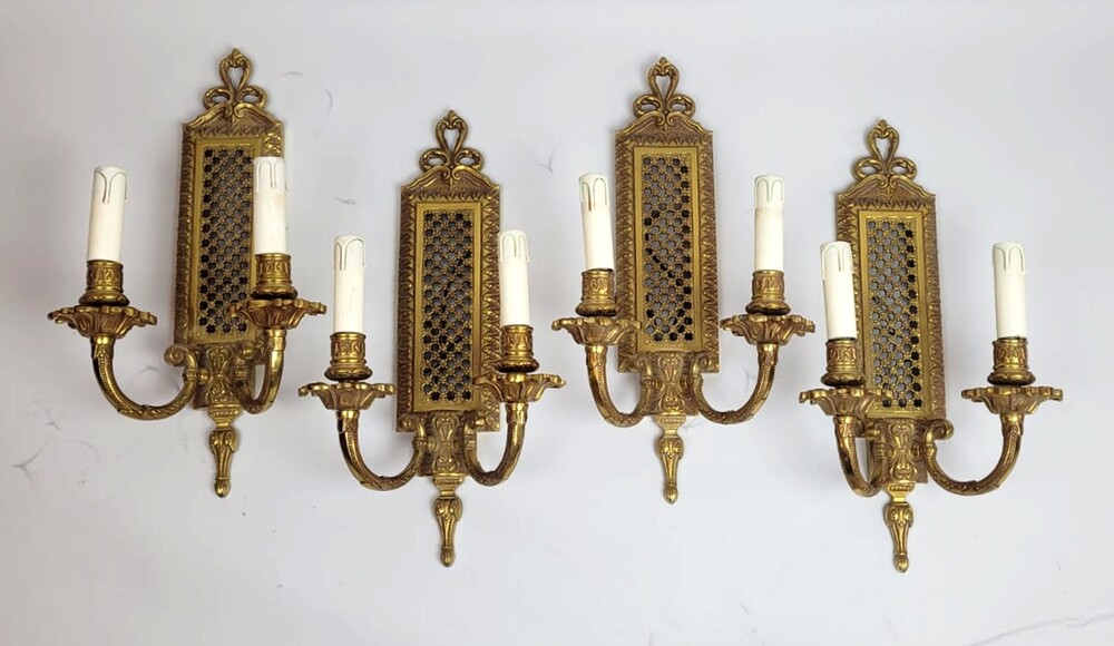 four Louis XVI style gilt bronze wall lights