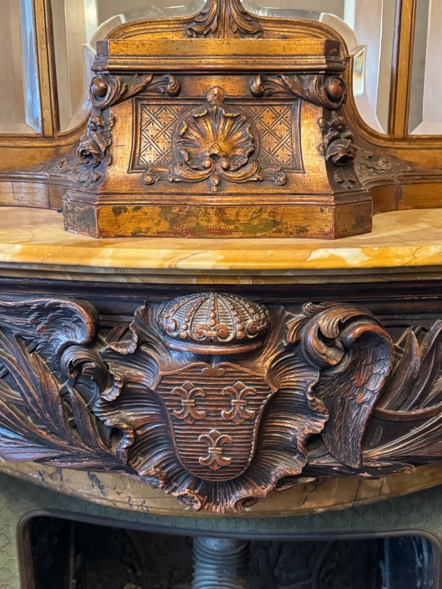 Impressive fireplace and its richly carved wooden trumeau highlighted with yellow Siena marble, circa 1900