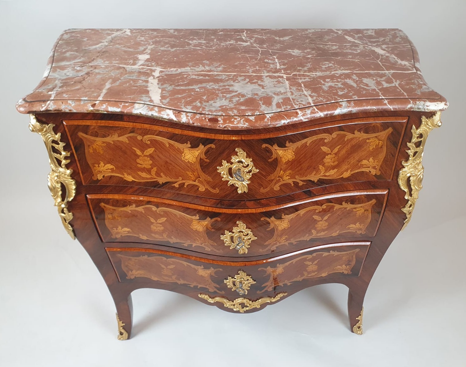 Louis XV style chest of drawers inlaid with rosewood and fruitwood