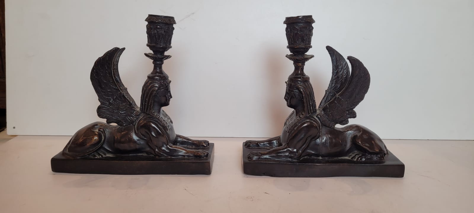 pair of bronze candlesticks with dark patina representing sphinxes - circa 1900