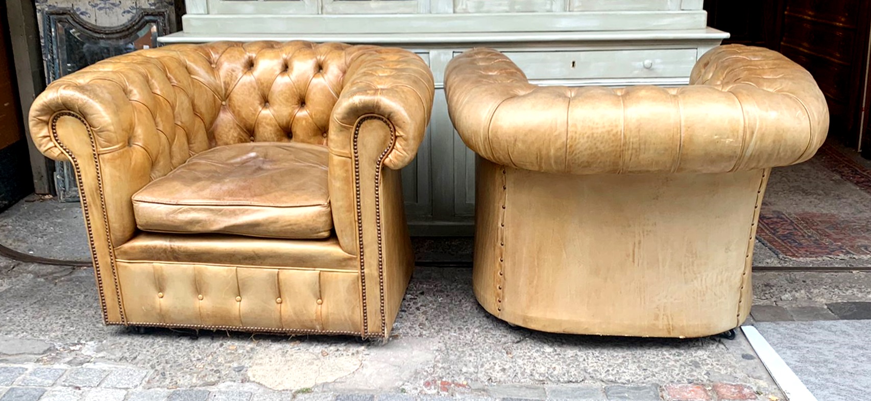 Pair of caramel-colored chesterfield armchairs