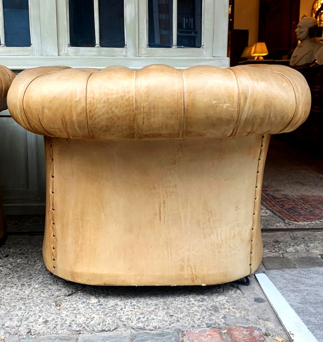 Pair of caramel-colored chesterfield armchairs