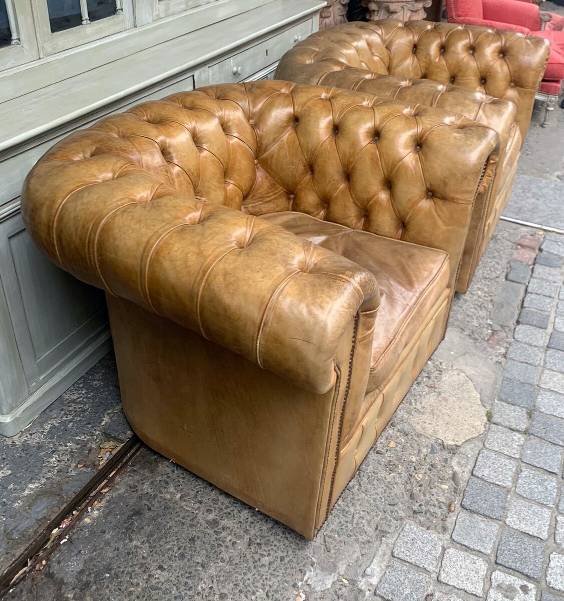 Pair of caramel-colored chesterfield armchairs