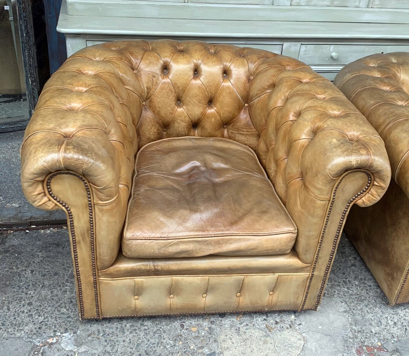 Pair of caramel-colored chesterfield armchairs