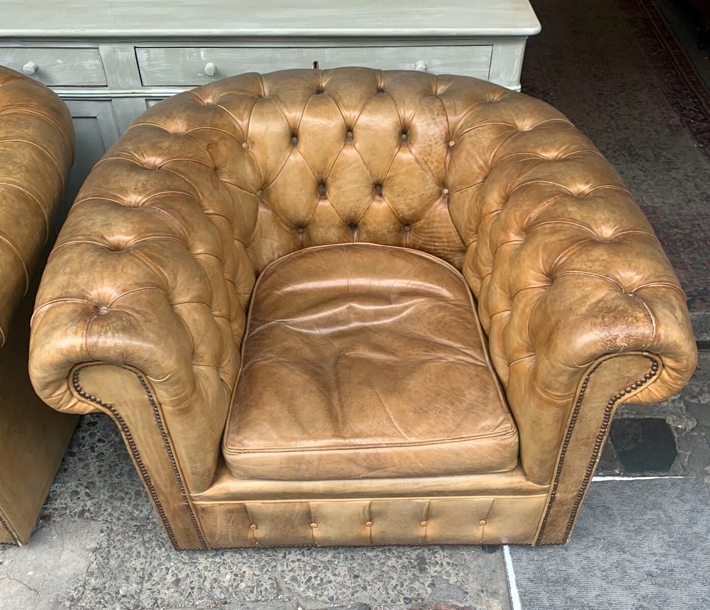 Pair of caramel-colored chesterfield armchairs