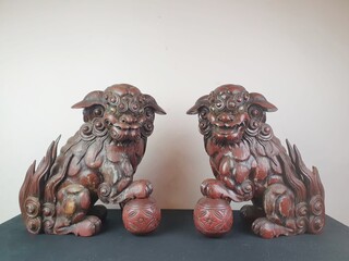 Pair of finely carved red lacquered wood Fô dogs