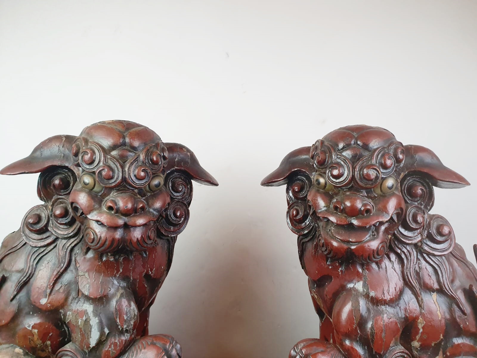 Pair of finely carved red lacquered wood Fô dogs