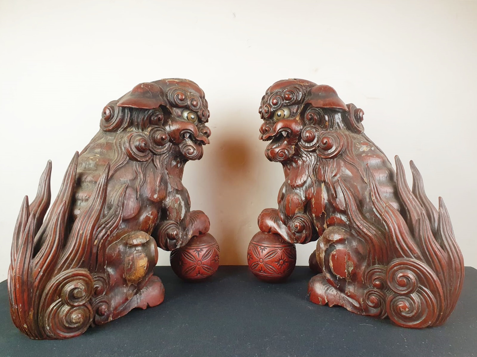 Pair of finely carved red lacquered wood Fô dogs