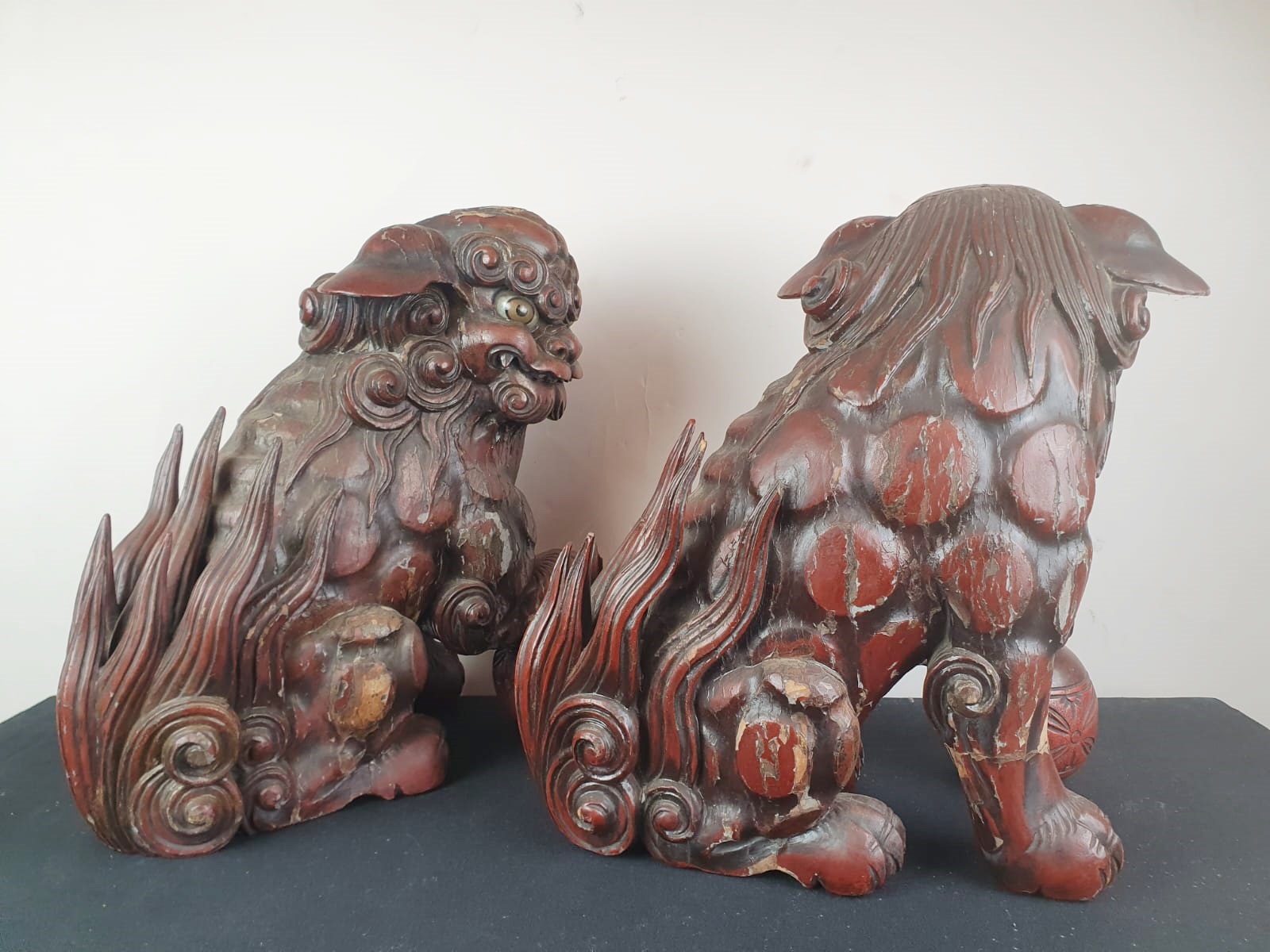 Pair of finely carved red lacquered wood Fô dogs