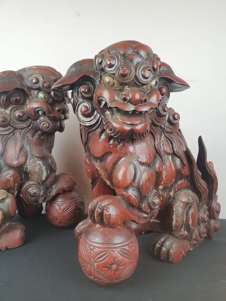 Pair of finely carved red lacquered wood Fô dogs