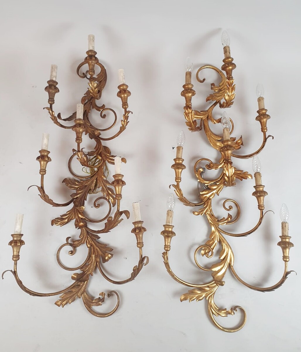 Pair of large wrought iron and gilded sheet metal wall lights, circa 1960 (Tainted patina on one of them)