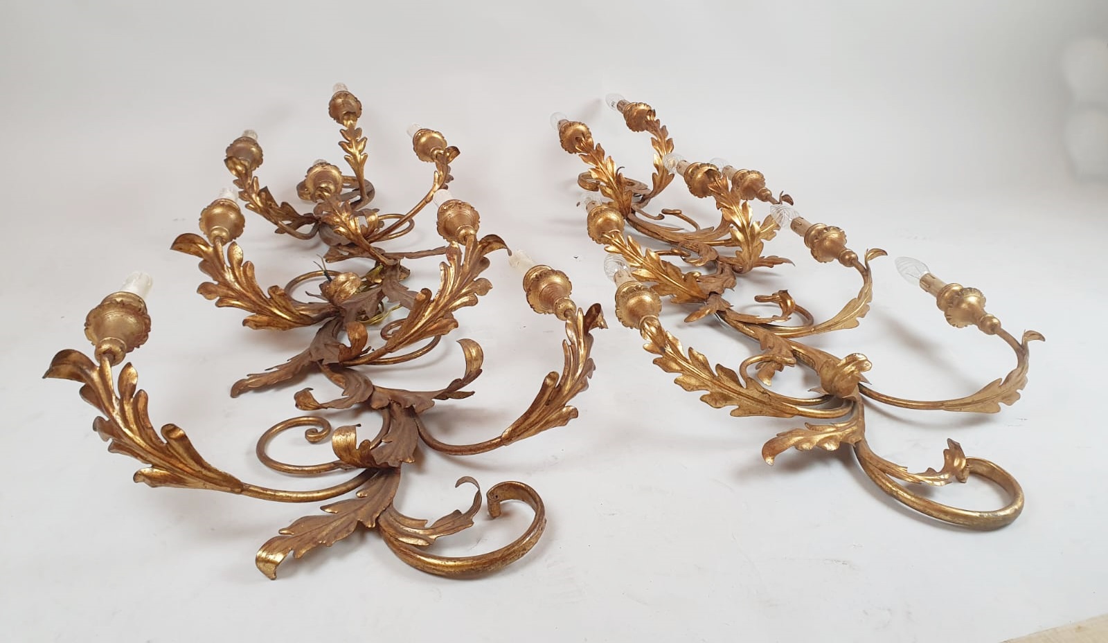 Pair of large wrought iron and gilded sheet metal wall lights, circa 1960 (Tainted patina on one of them)