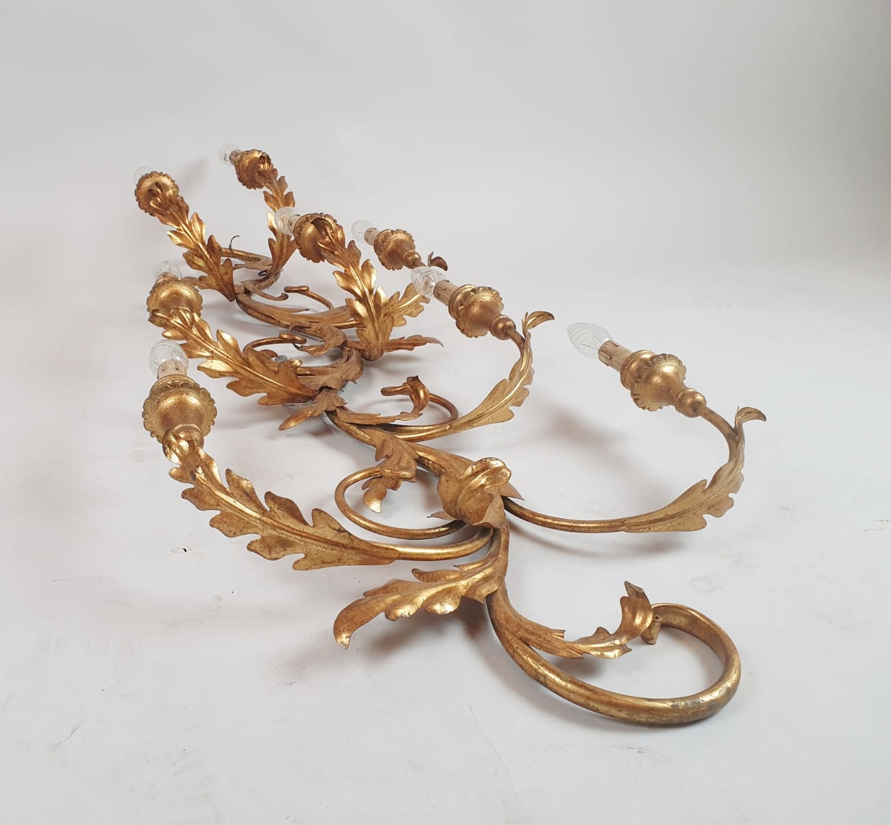 Pair of large wrought iron and gilded sheet metal wall lights, circa 1960 (Tainted patina on one of them)