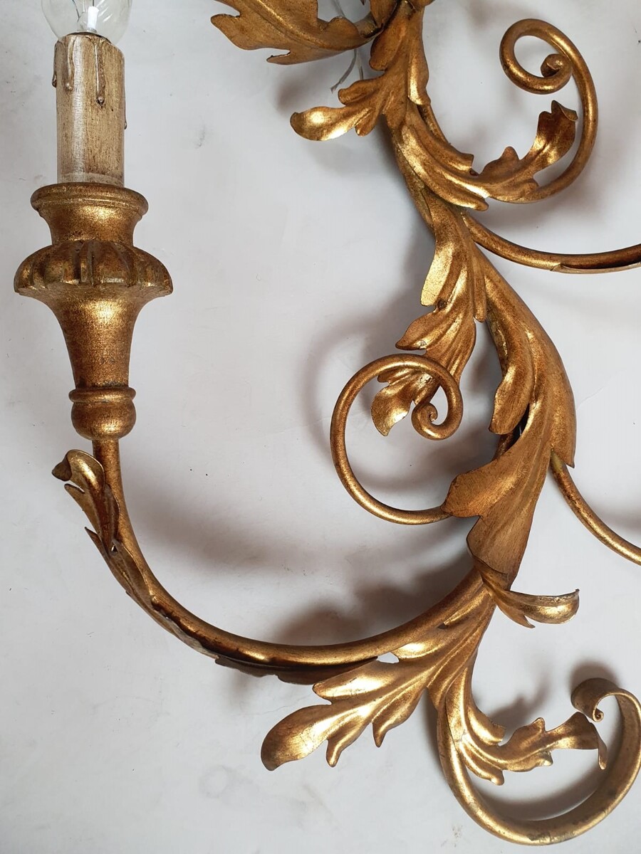 Pair of large wrought iron and gilded sheet metal wall lights, circa 1960 (Tainted patina on one of them)