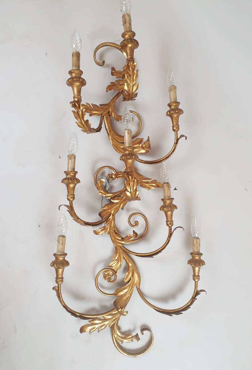 Pair of large wrought iron and gilded sheet metal wall lights, circa 1960 (Tainted patina on one of them)