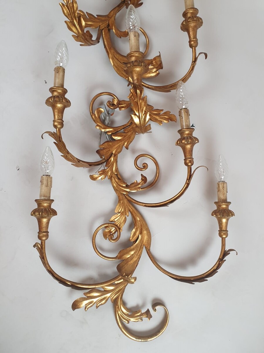 Pair of large wrought iron and gilded sheet metal wall lights, circa 1960 (Tainted patina on one of them)