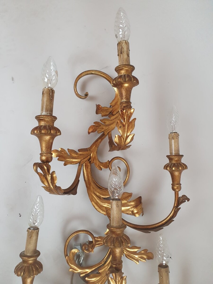 Pair of large wrought iron and gilded sheet metal wall lights, circa 1960 (Tainted patina on one of them)