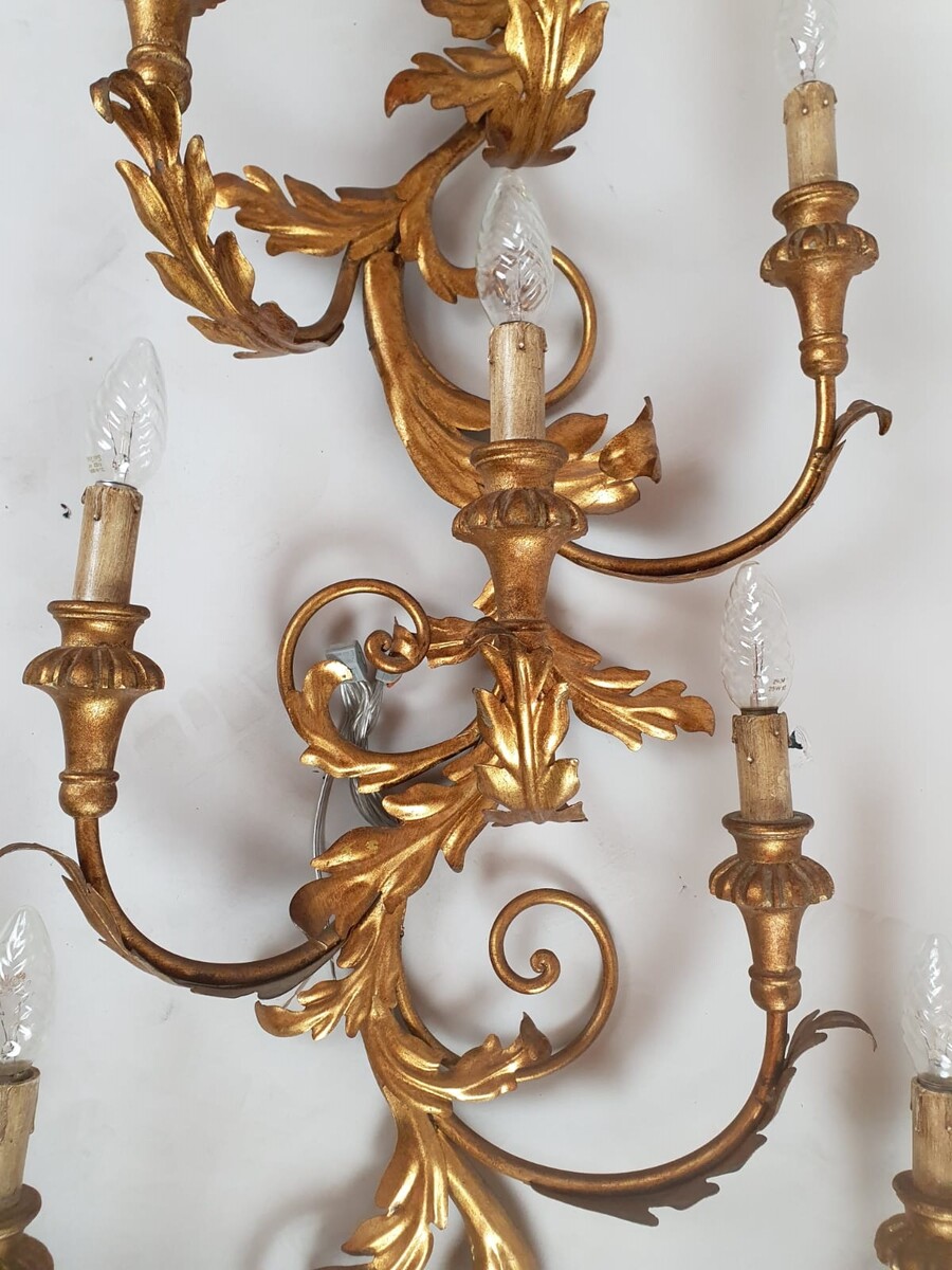 Pair of large wrought iron and gilded sheet metal wall lights, circa 1960 (Tainted patina on one of them)