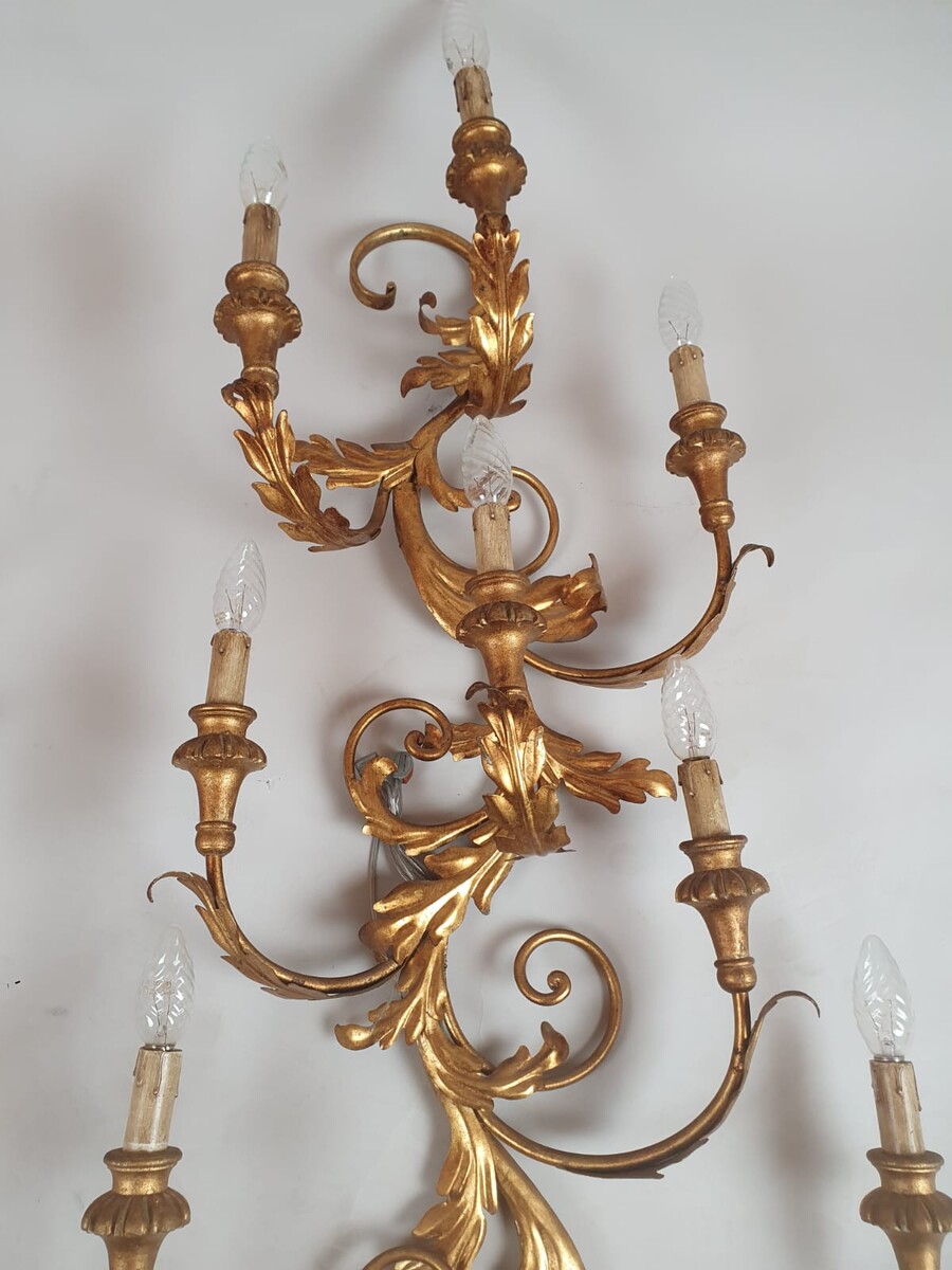 Pair of large wrought iron and gilded sheet metal wall lights, circa 1960 (Tainted patina on one of them)