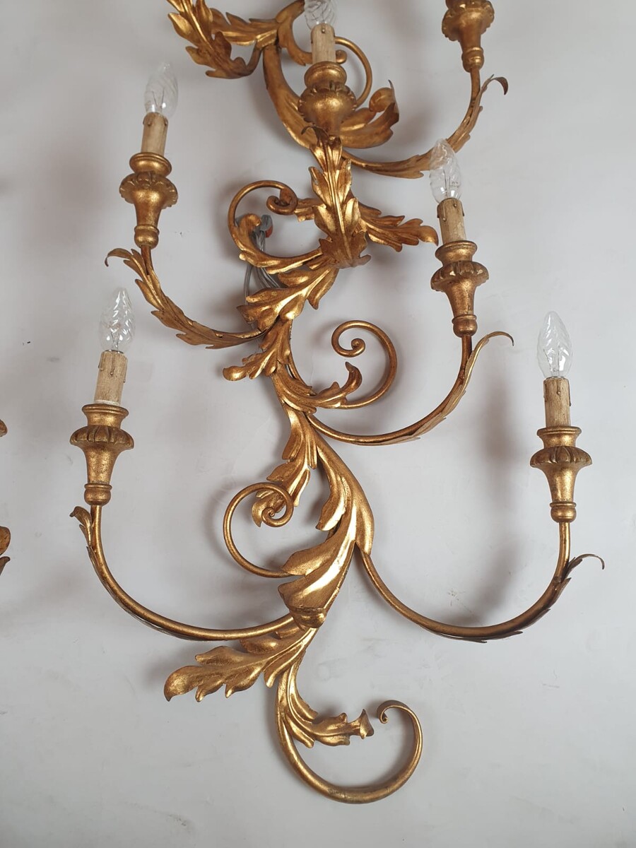 Pair of large wrought iron and gilded sheet metal wall lights, circa 1960 (Tainted patina on one of them)