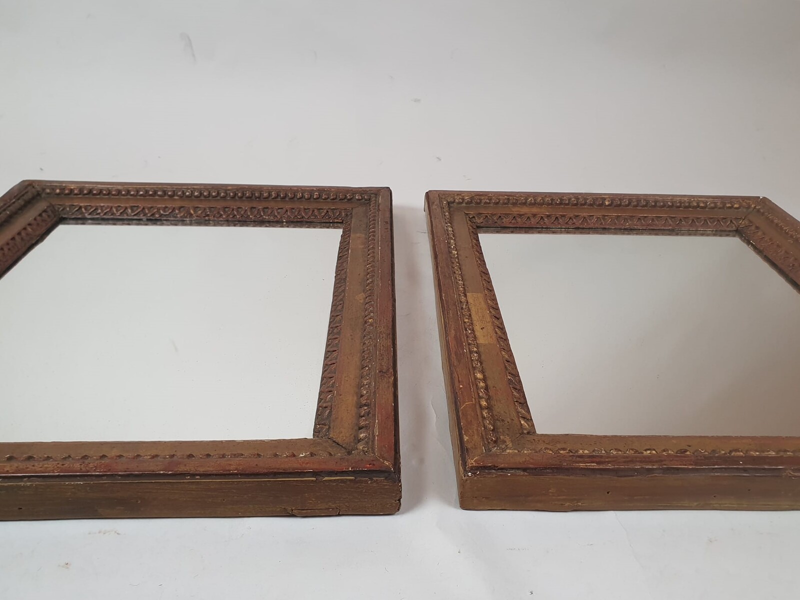 Pair of Louis XVI period mirrors in gilded wood