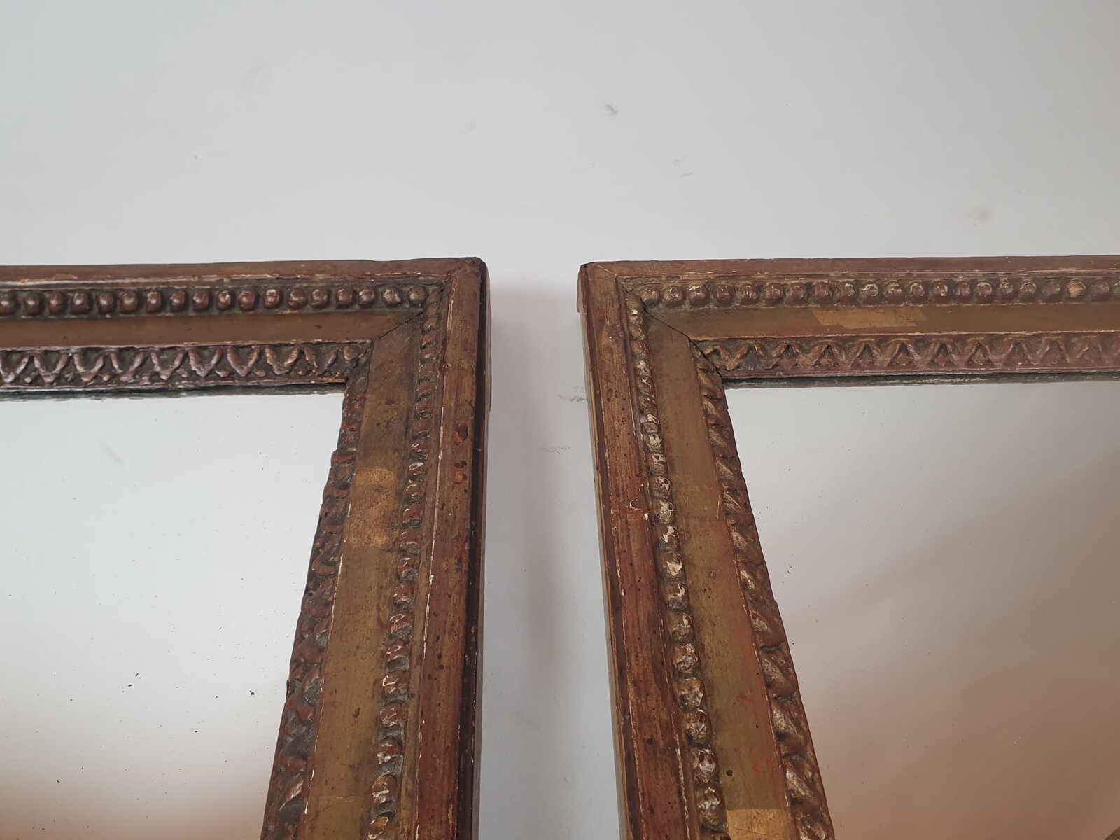 Pair of Louis XVI period mirrors in gilded wood