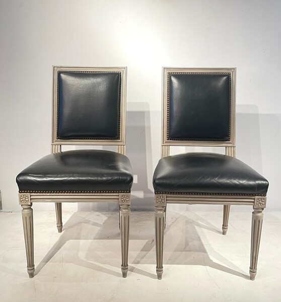 Pair of Louis XVI style chairs in weathered wood and black leather seats