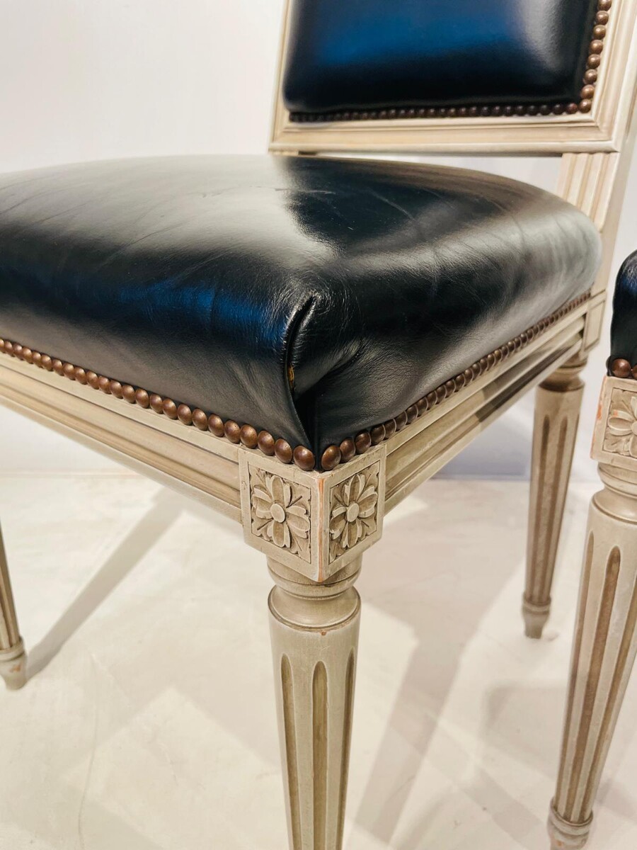 Pair of Louis XVI style chairs in weathered wood and black leather seats