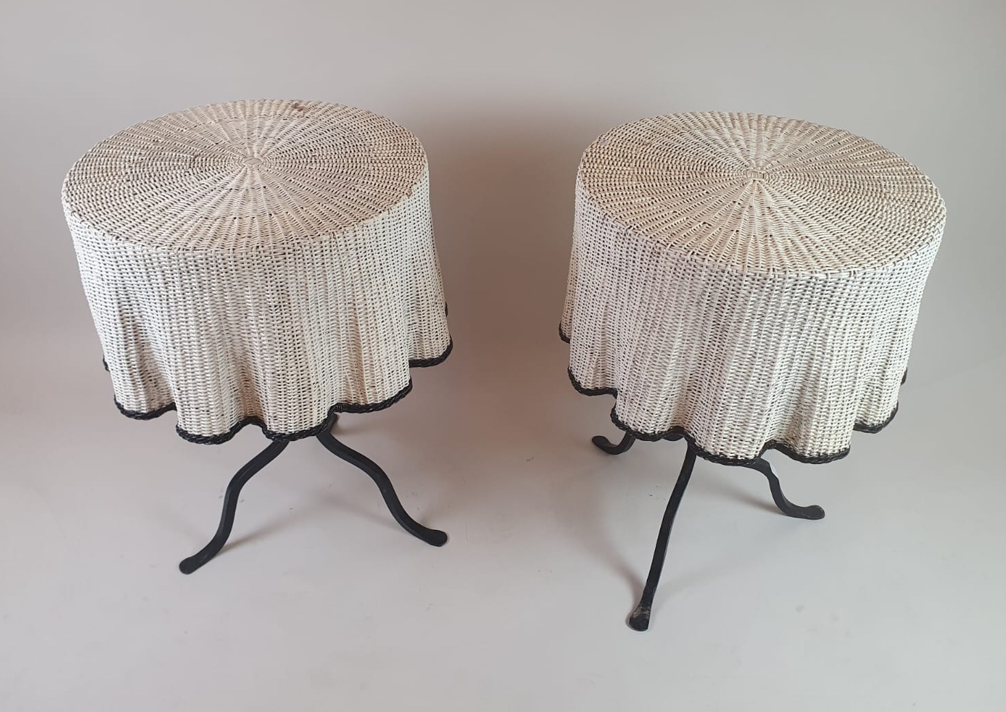 Pair of side tables, wrought iron base and wicker shelf imitating a drape