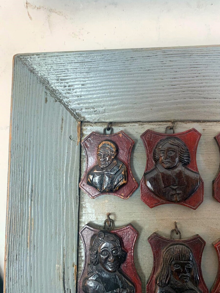 set of 3 frames containing small carved wooden medallions (famous people)