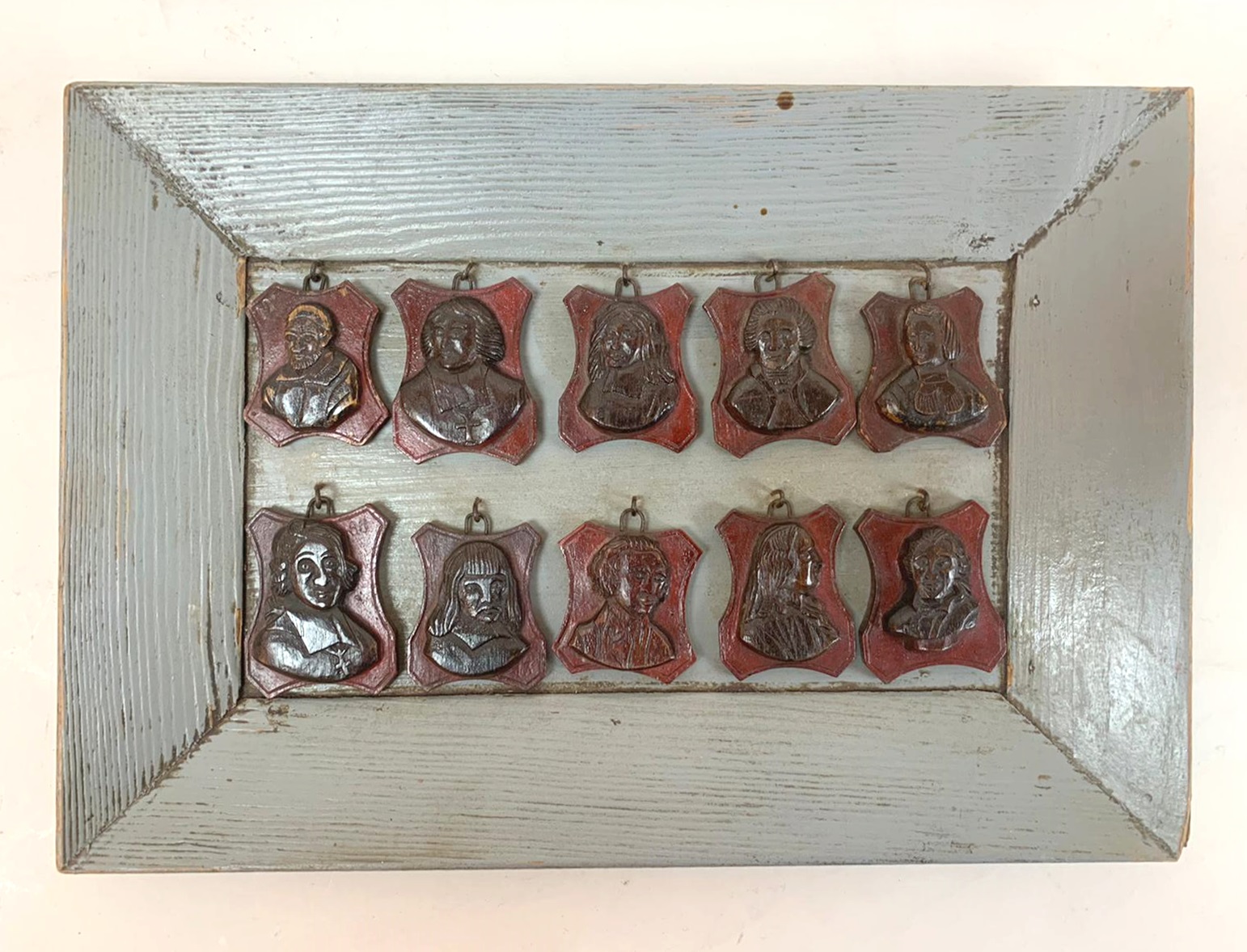 set of 3 frames containing small carved wooden medallions (famous people)