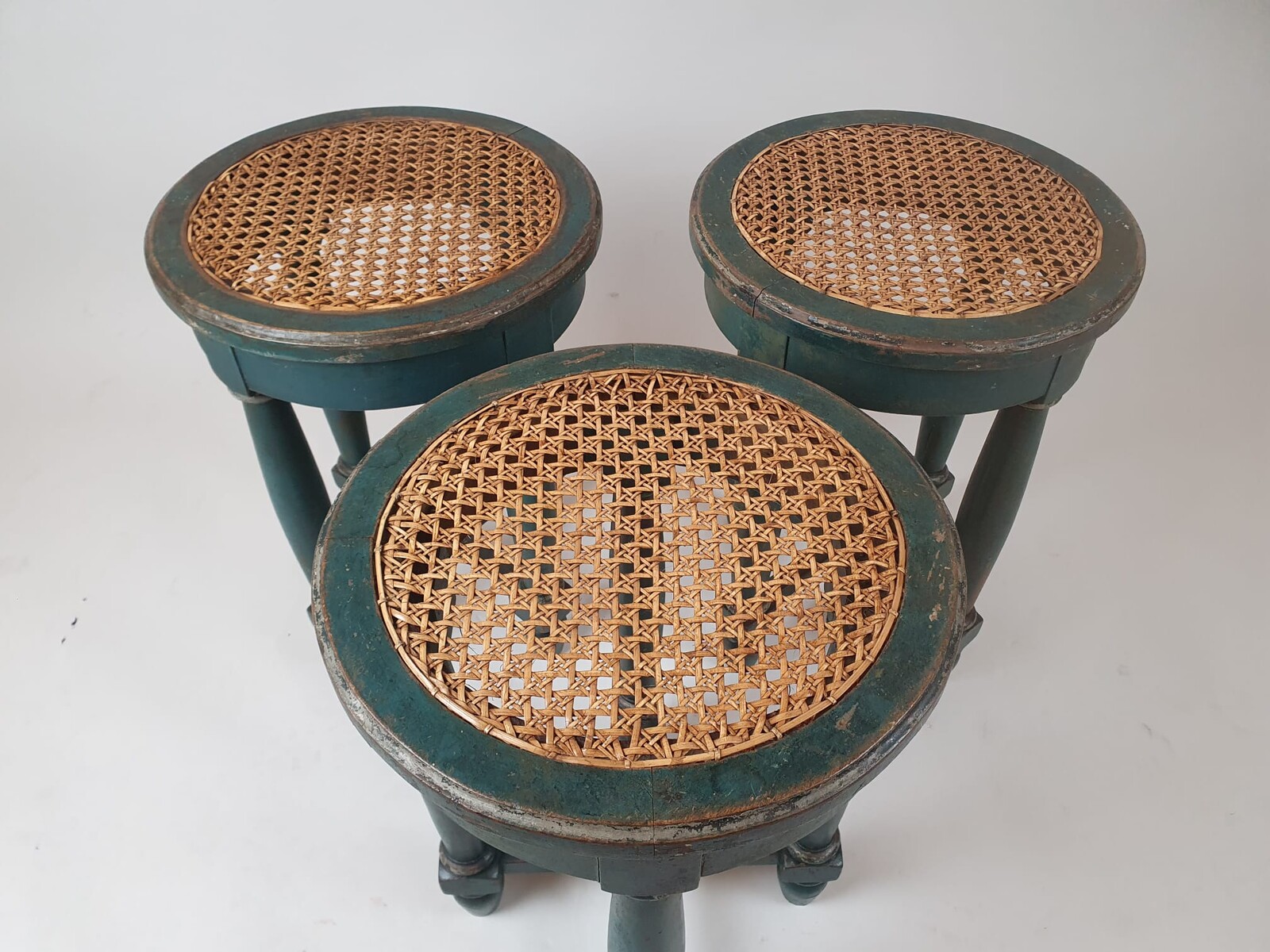 Set of 3 stools in green patinated wood, caned seats, 19th century