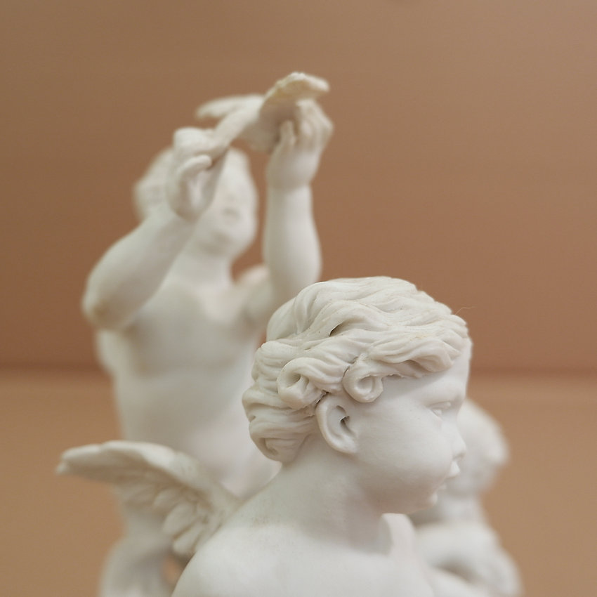 Three cherubs in white porcelain biscuit 19th