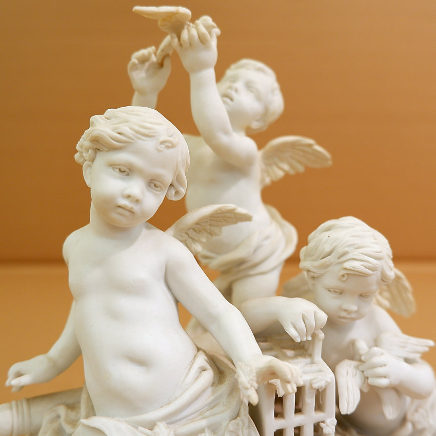 Three cherubs in white porcelain biscuit 19th