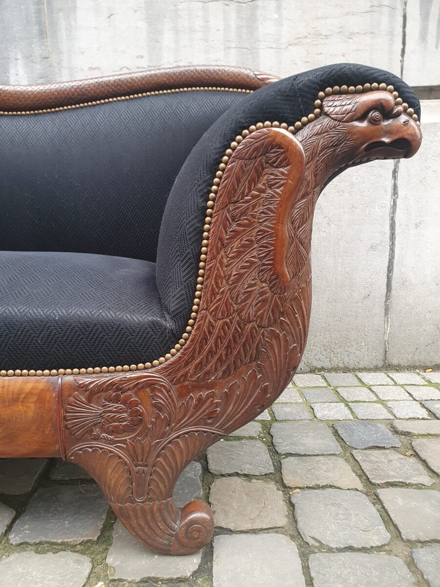 Walnut chaise longue carved with eagle and fish motifs (a few small snags in the veneer)